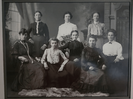 Bessie is front row, second from left and Bea is front row, second from right. Their mother is between them.